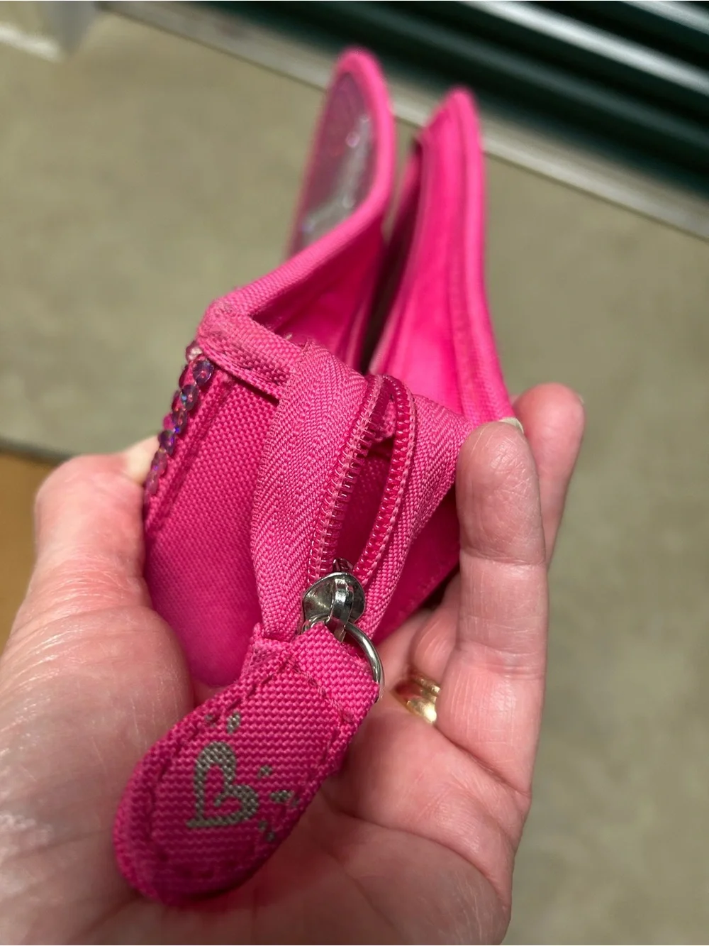 Hot pink, 3 ring binder notebook that zips up and has sequins on the front.